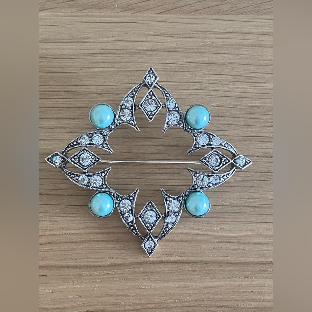 Silver tone brooch in modern design